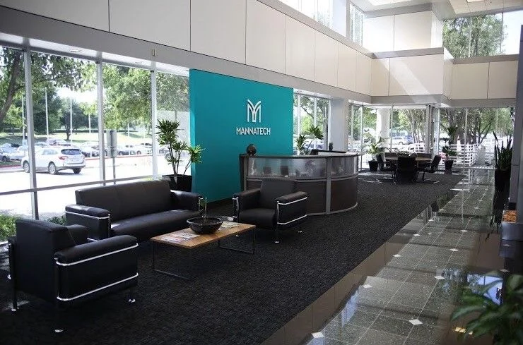 Reception area at Mannatech's head office, with the Mannatech logo on a teal wall