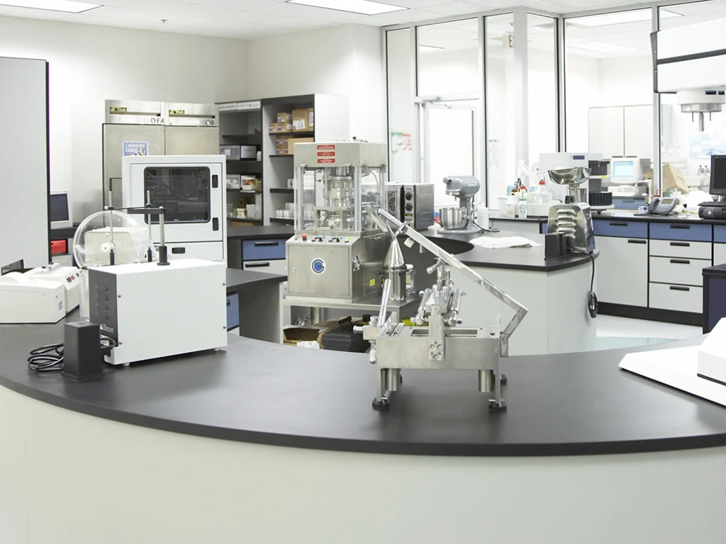 Product development laboratory at Mannatech, with tablet presses and testing equipment